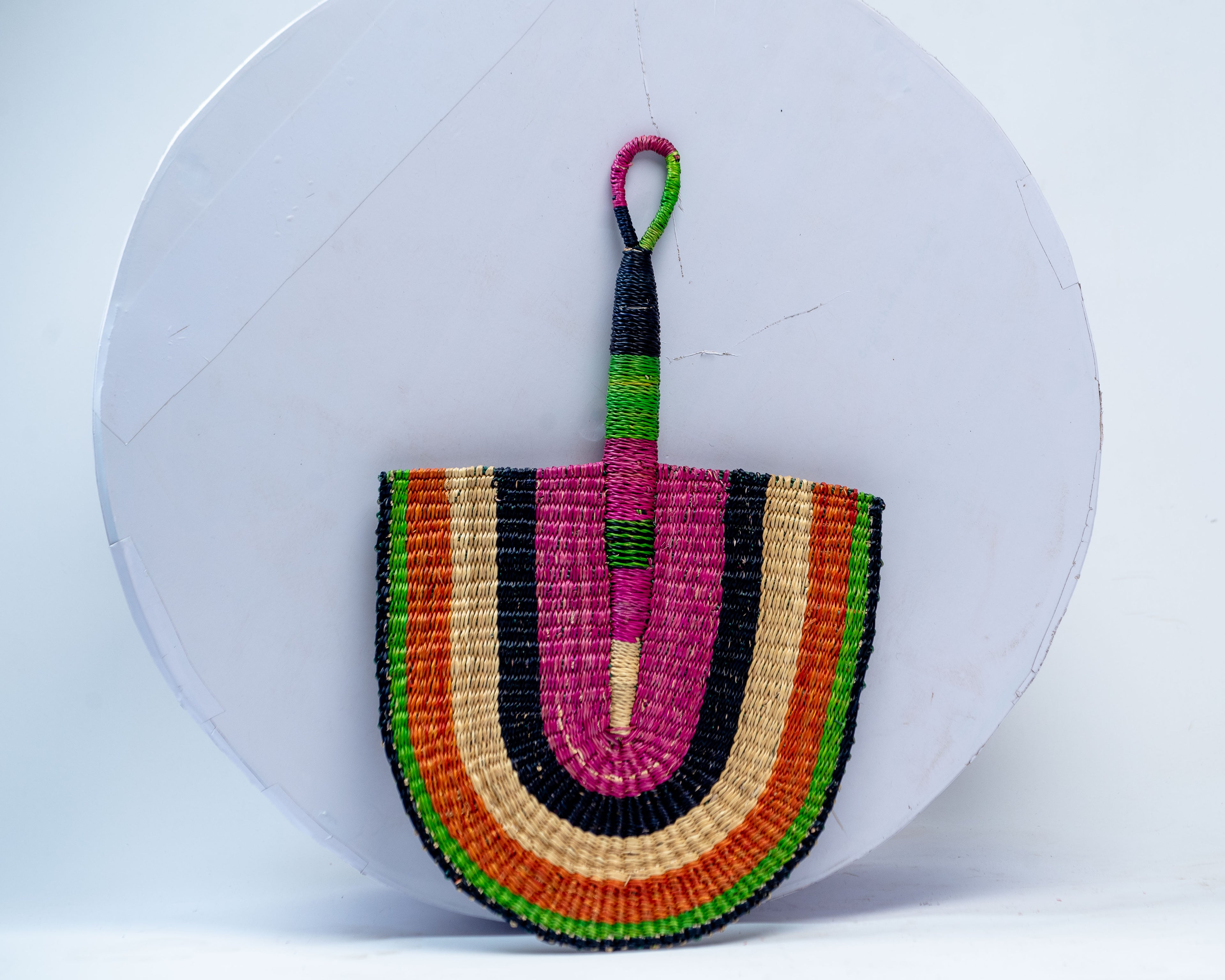 Handwoven Bolga Rainbow Fan – Magenta, Orange, Green & Black Concentric Stripes