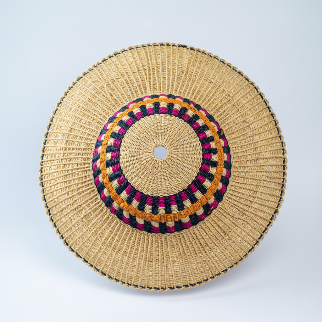 Handwoven Bolga sun hat with magenta and amber band, top-down view