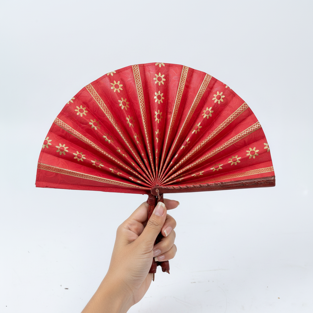Handmade red and gold circular folding fan, angled view showing pleated construction