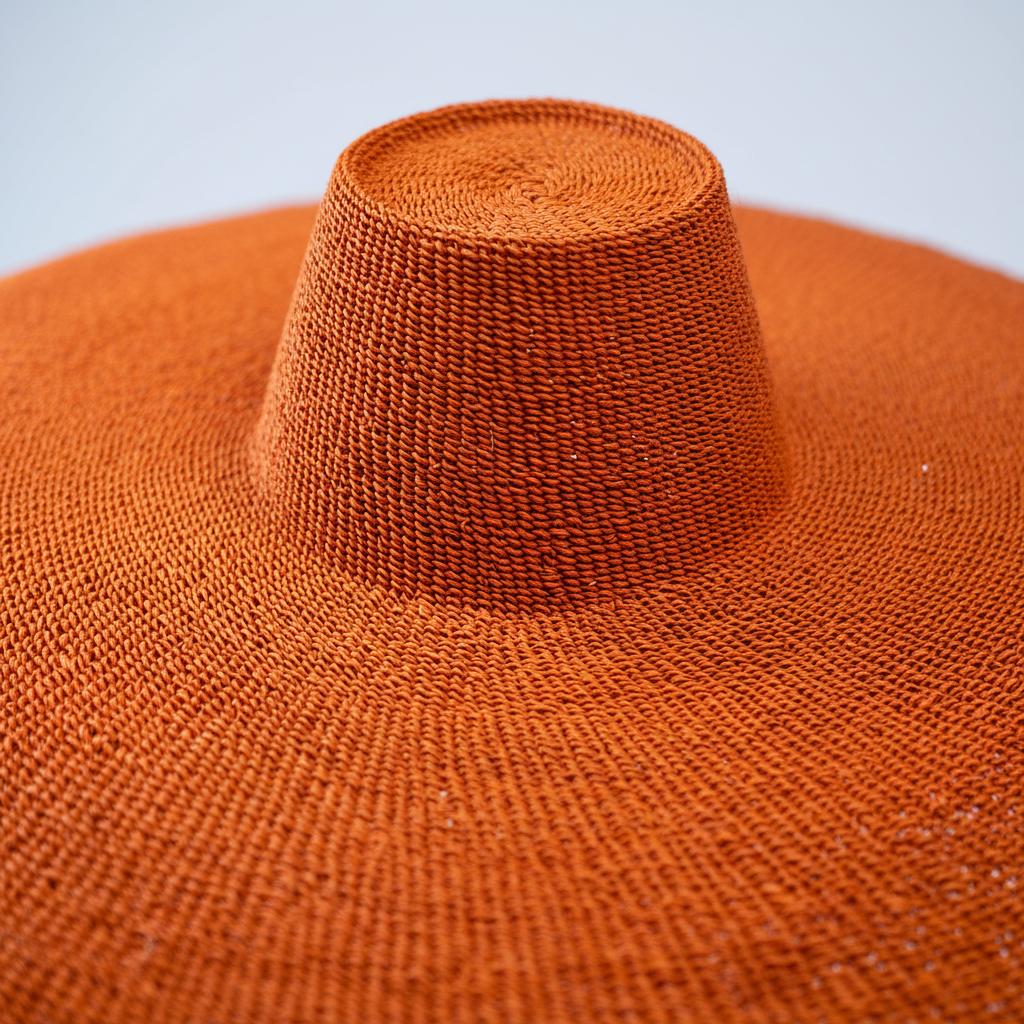 Close-up of tight terracotta orange spiral weave detail